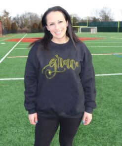 A woman on a field wearing a black outfit