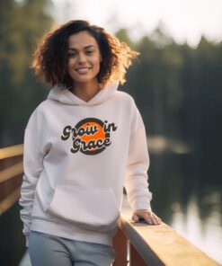 Smiling woman wearing "Grow in Grace" hoodie
