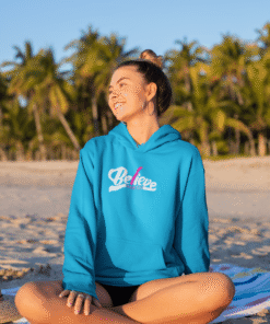 Smiling woman in blue hoodie on beach
