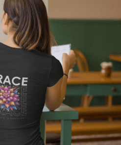 Woman reading in cafe wearing GRACE floral shirt