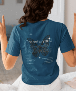 Person wearing blue "Transformed" t-shirt showing peace signs