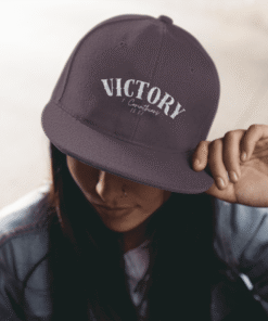 Person adjusting Victory baseball cap