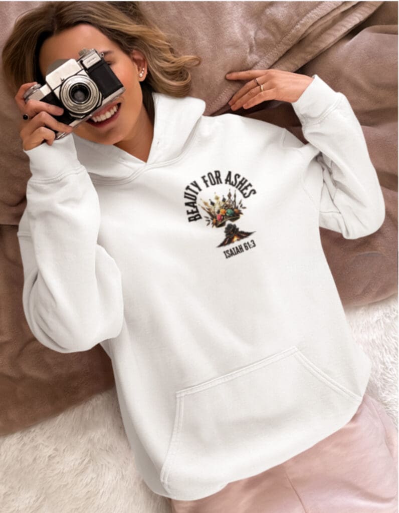 Person wearing Beauty for Ashes hoodie holding camera