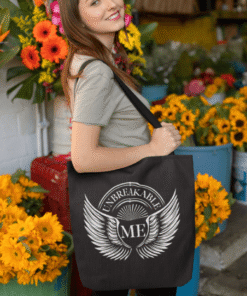 Woman holding "Unbreakable Me" tote at flower shop